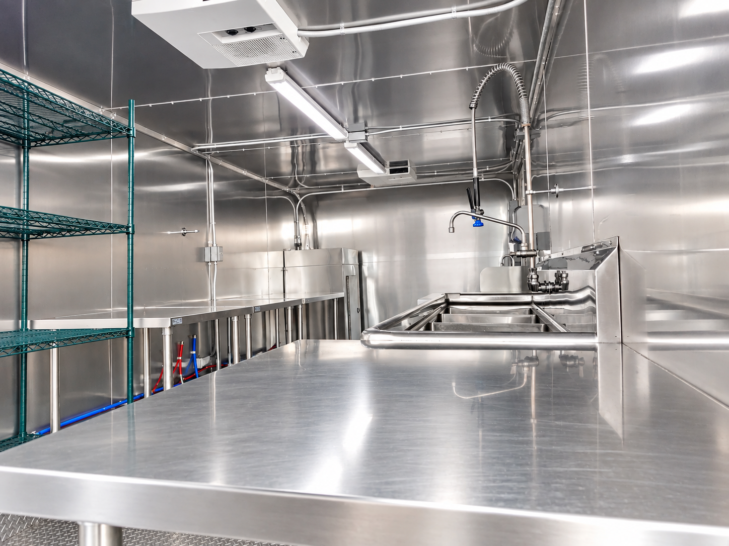 Stainless workstation inside a commercial dishwashing trailer